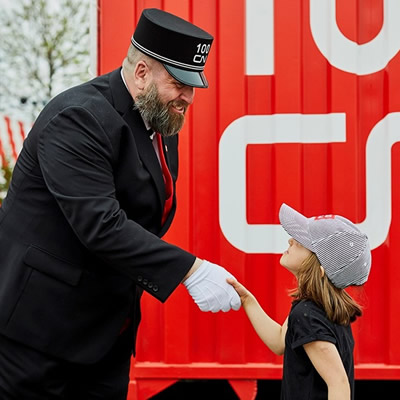 CN conductor shaking hands with young girl. 