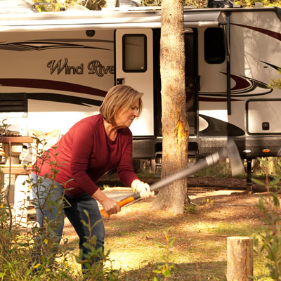 Woman using an ax to cut wood. 