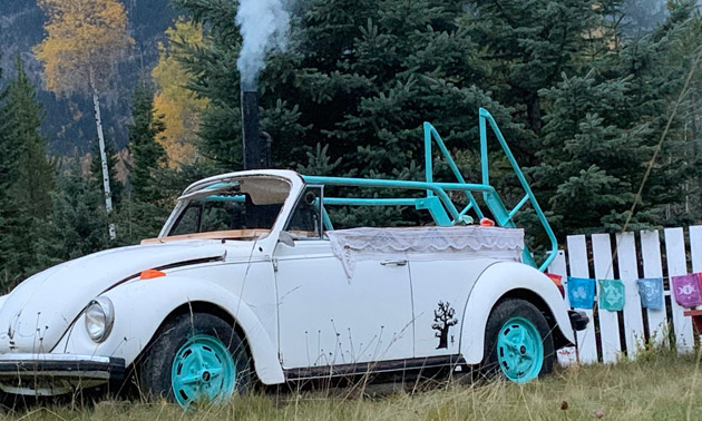 White VW Beetle with hot tub in it.