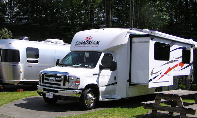 A CanDream rental motorhome with a slideout parked at a campground. 