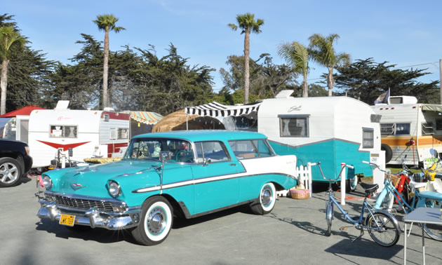 A 1956 tropical turquoise Chevrolet Bel Air along with a matching 1961 Shasta Compact travel trailer.