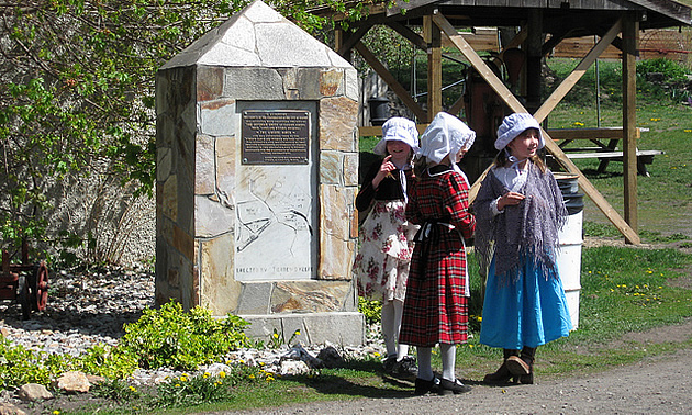 Three girls dressed in period costume at Historic O'Keefe Ranch