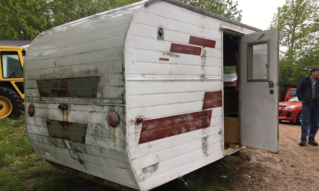 Picture of trailer, with red stripes and damage on back end. 