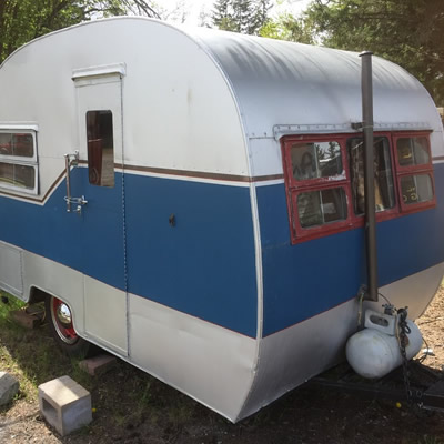 A blue and white Cozy Cruiser trailer. 