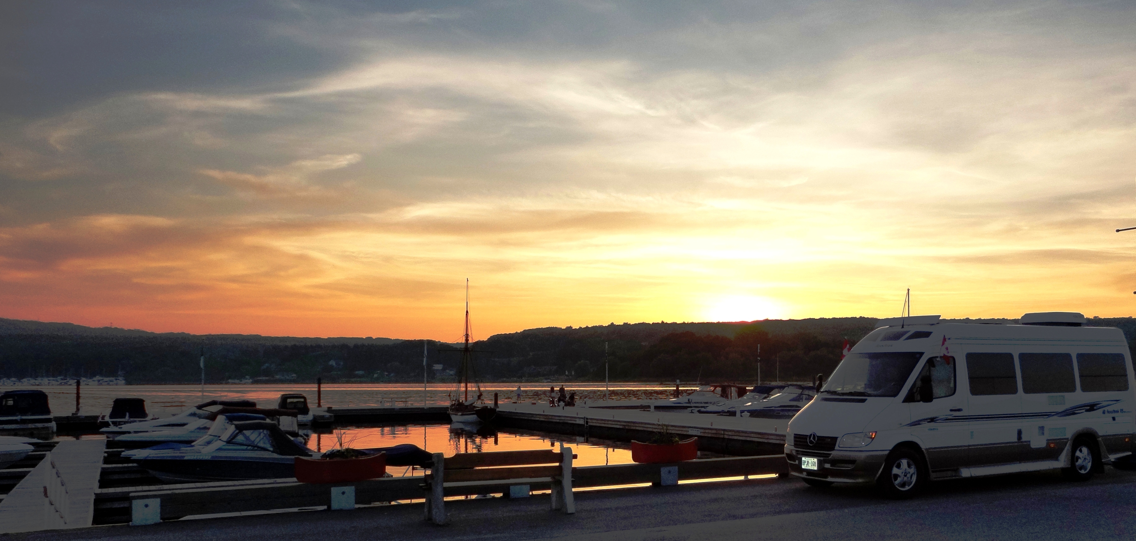 Photo of a marine in the foreground, with a sunset in the background. 