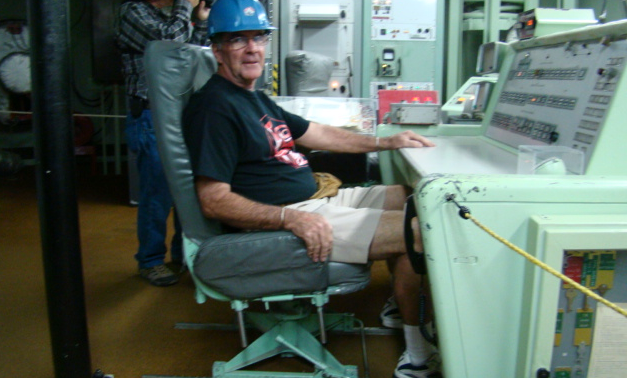 Man wearing hardhat sitting at a desk