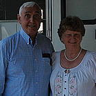 Elderly couple standing beside their RV