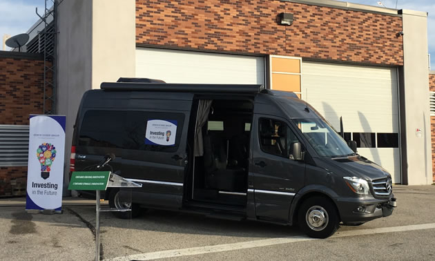 Picture of black Erwin Hymer van in parking lot. 