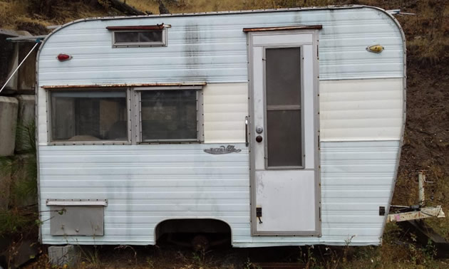 Outside of Esta Villa trailer before it was restored, trailer is rundown and rusty. 