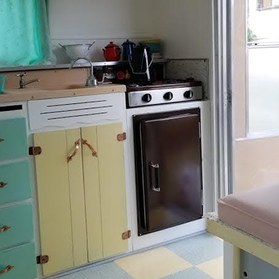 Interior of Esta Villa trailer, pink, yellow and turquoise decor.