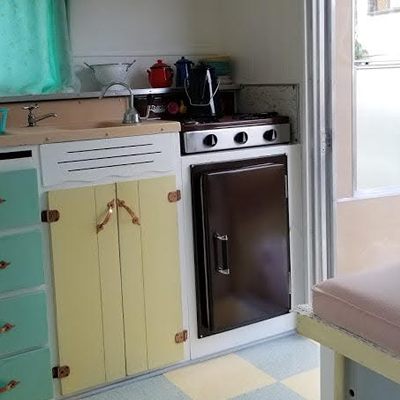 Interior of Esta Villa trailer, pink, yellow and turquoise decor. 