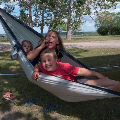 These three cousins are enjoying grandma’s homemade cookies in a hammock.