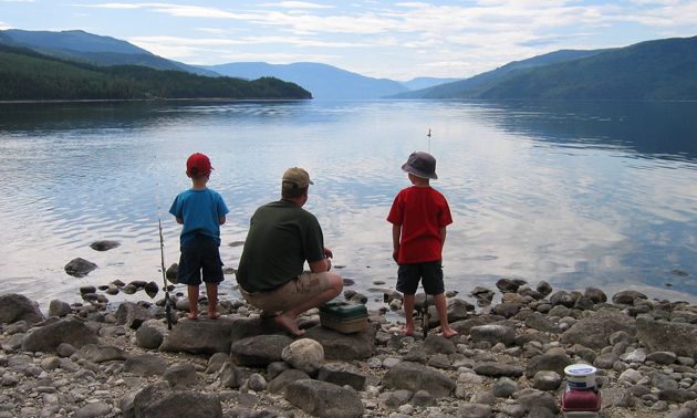 kids learning to fish on a lake