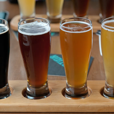 This sample flight includes (left to right) stout, red ale, IPA and a wheat beer, but drink these right to left.