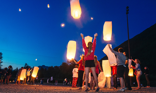 Families release wish lanterns into the night sky