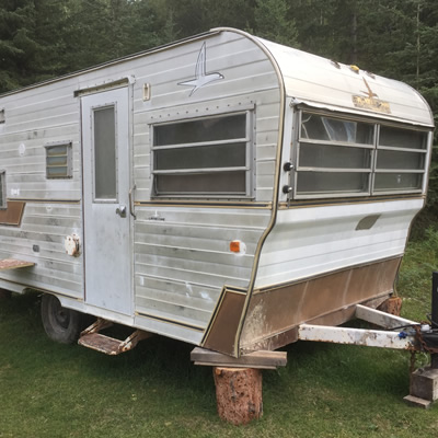 A worse-for-wear Golden Falcon travel trailer. 