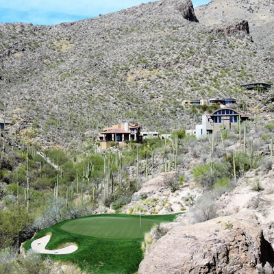 The third hole of the Mountain Course at Ventana Canyon in Tucson, Arizona, is surrounded by saguaro cacti and a desert landscape. 