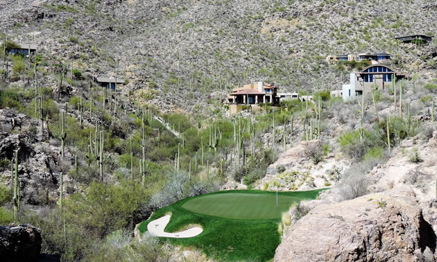 The third hole of the Mountain Course at Ventana Canyon in Tucson, Arizona, is surrounded by saguaro cacti and a desert landscape. 