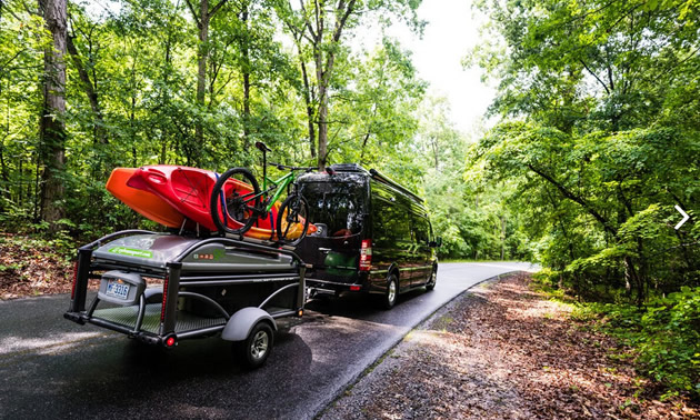 Vehicle towing a Go Sport trailer. 