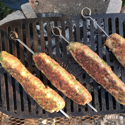 Meat skewers on grill. 