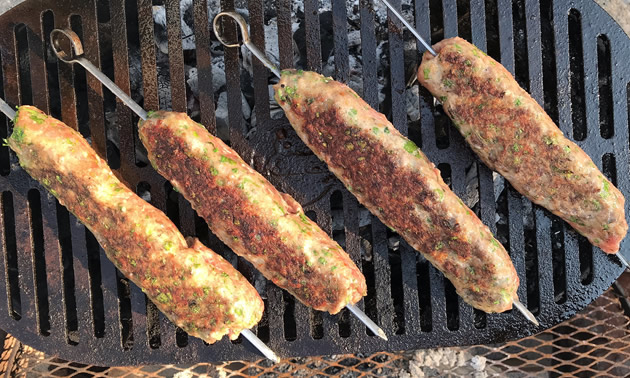 Meat skewers on grill. 