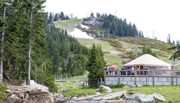 Tourists standing on the porch of the yurt lookout at Grouse Mountain