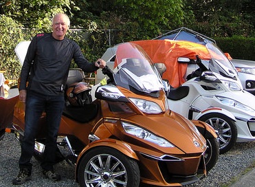 François Guite standing next to his Spyder that brought him from Quebec to Vancouver