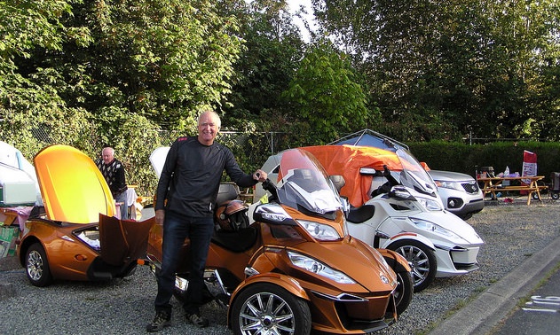 François Guite standing next to his Spyder that brought him from Quebec to Vancouver