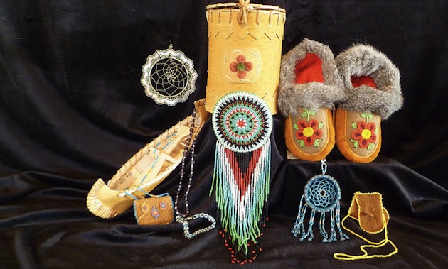 A display of native items, including  beaded moccasons, a miniture canoe, dreamcatcher and a beaded purse  from the Mackenzie Crossroads Museum and Visitor centre at High Level. 