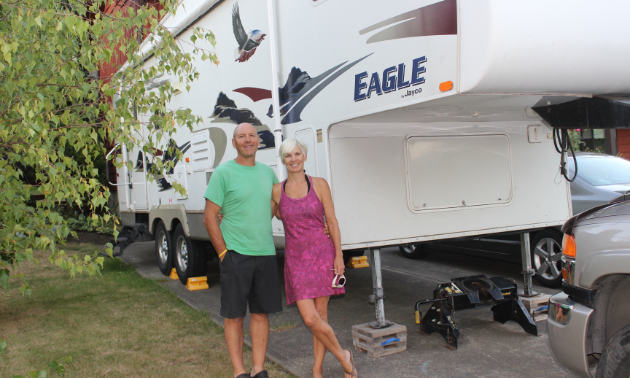 John and Shelley Smith stand proudly beside their 2006 28-foot Eagle fifth wheel.