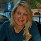 Smiling young blonde woman wearing a long-sleeved teal blue T-shirt