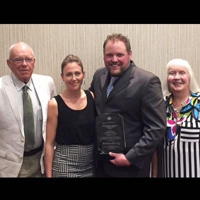 Jason Bell, surrounded by family, was awarded the Walter Paseska Memorial Canadian RV Dealer of the Year Award. 