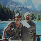 couple standing by an alpine lake