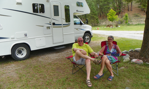 Peter and Margreet relax in their Canadian camping chairs in a quiet RV lot.