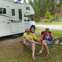 Peter and Margreet relax in their Canadian camping chairs in a quiet RV lot.