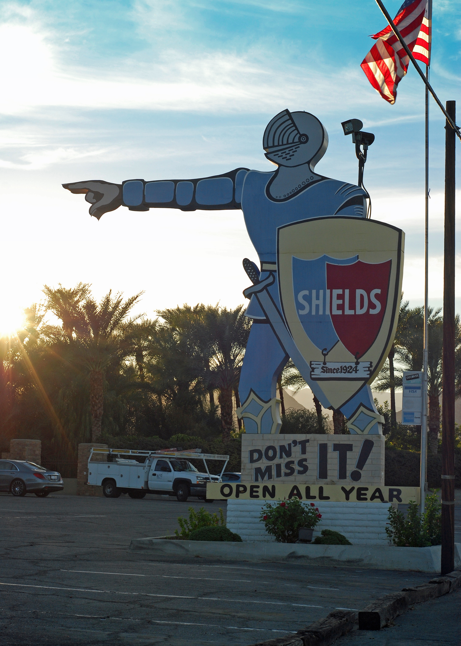 A sign depicting a knight points to Shields Date Garden.