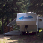 camper parked in a treed site