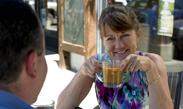 A woman drinking coffee outside a Merritt, B.C. cafe.