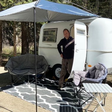 A Bowler with Phil standing at the door under the MoonShade awning