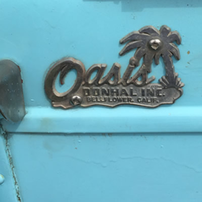 The Oasis Travel Trailer company logo. 