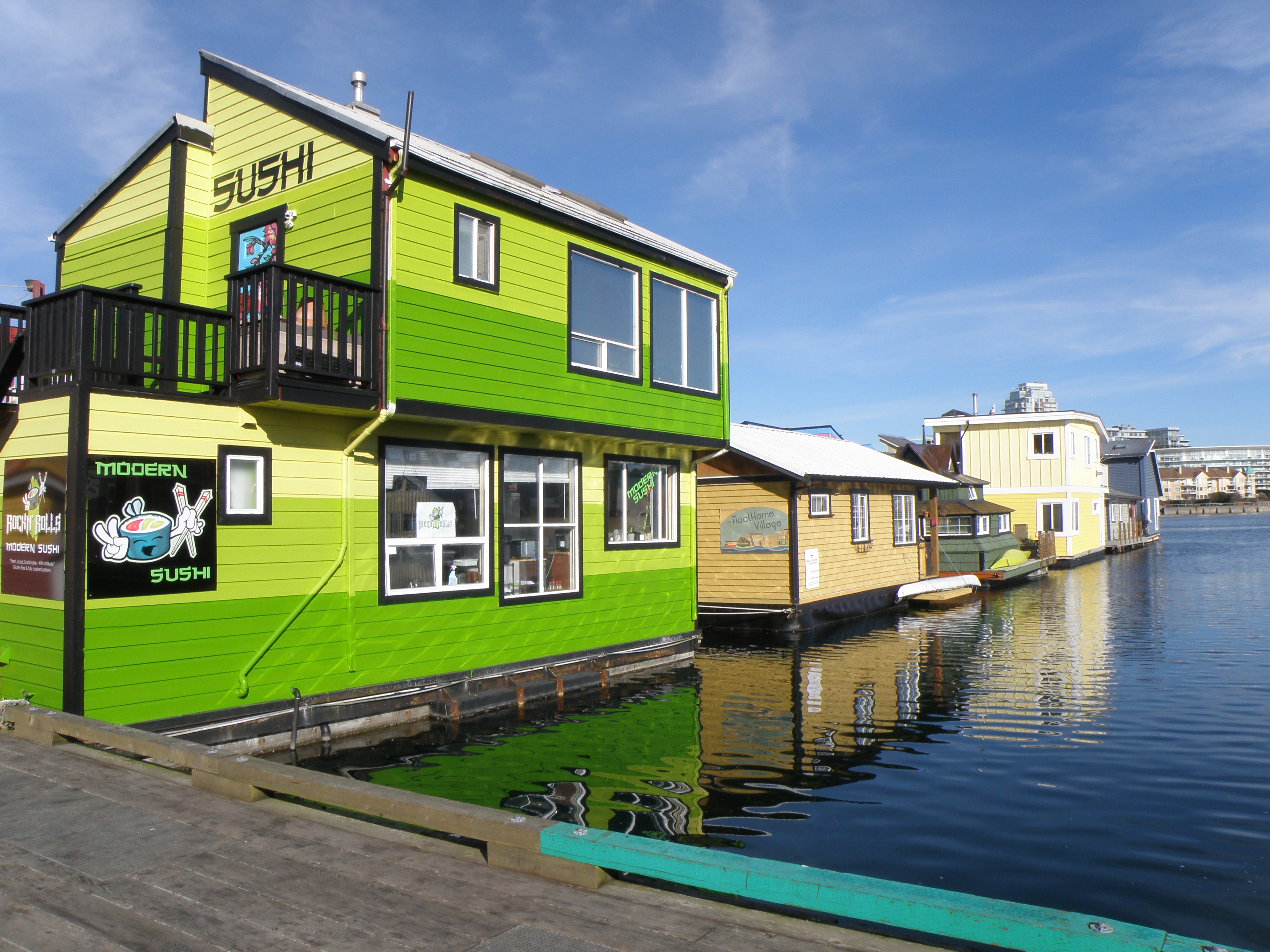 A lime green floating house boat. 