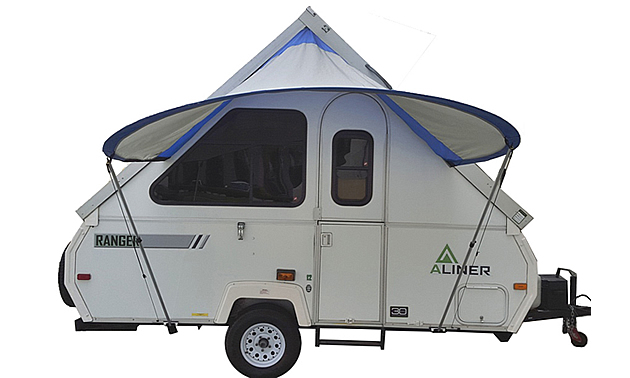 A framed towable trailer with the PahaQue Visor open and installed providing shelter from the rain and protection from the sun