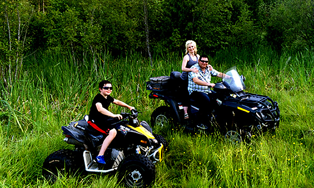 Eric Buckley, Nicole Lind and Will Buckley quadding in a field in the Pend d'Oreille region in B.C.