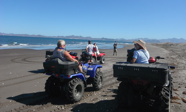 Sea and sky make a beautiful backdrop for quad riders on the beach