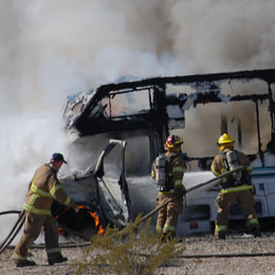 Picture of three firemen putting out RV fire 