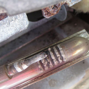 A Dometic fridge burner assembly plugged by a mud dauber