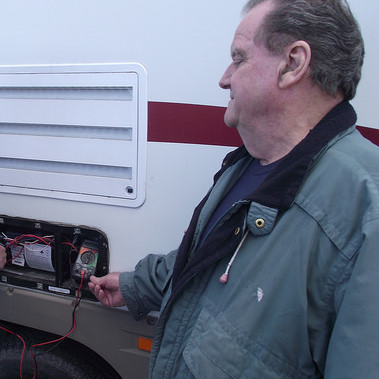 Runners RV service technician Lloyd Panchuk checks voltage on a furnace as Service Manager Tom Gilgan look on.