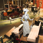 interior of museum with horse-drawn carriages on display