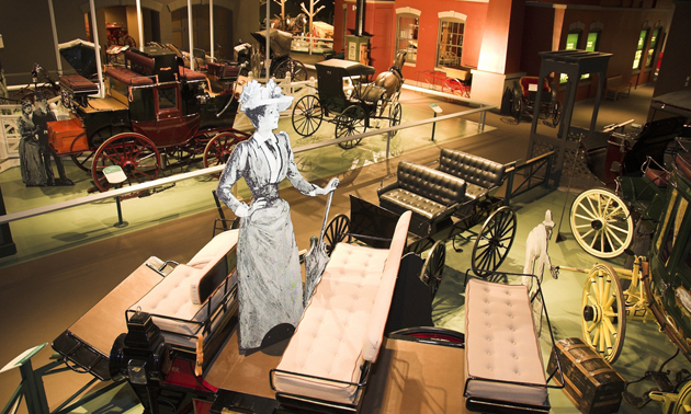 interior of museum with horse-drawn carriages on display