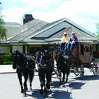 an old-fashioned carriage drawn by a team of two horses 